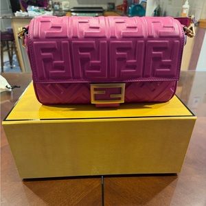 Brand new. Baguette style pink Fendi bag. Comes with long strap. Butter soft.